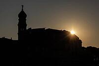 Sunrise behind the bell tower of the Assumption Cathedral with baroque onion dome and trumpet blowing angel, old town of Krk, island of Krk, Croatia [IBR125415397]