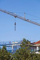 Shell of a residential building with scaffolding, construction crane and blue safety net, residential construction, Emden, East Frisia, Lower Saxony, Germany [IBR125415407]