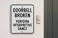Sign displaying a humorous message about a broken doorbell, suggesting an interpretive dance as a creative alternative for communication, AI generated [IBR125421185]
