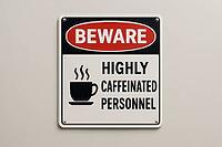 Humorous sign warning about highly caffeinated personnel, ideal for concepts related to coffee, work, and humor, AI generated [IBR125421200]