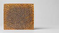 Cross-section of cured epoxy underfill with densely distributed spherical silica filler particles, translucent amber matrix, studio shot, AI generated [IBR125421245]
