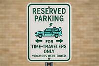 Close up of a funny reserved parking sign for time travelers only, featuring a stylized car with an open trunk and a lightning bolt, AI generated [IBR125421249]