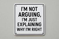 White sign on a gray wall humorously explaining why someone is right, cleverly addressing the quirks of arguing and differing opinions, AI generated [IBR125421250]