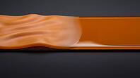 Abstract material surface transitioning from soft rippled texture to hard glassy reflective surface, representing epoxy vitrification, dark background, polymer science concept, AI generated [IBR125421264]