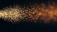 Abstract glowing amber particles densely clustered transitioning to diffuse soft light, representing diffusion controlled reaction, dark background, polymer science concept, AI generated [IBR125421266]