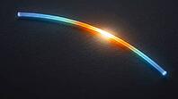 Abstract glowing blue to white yellow stress concentration gradient along a curved fiber line, dark background, aramid fiber engineering stress analysis concept, AI generated [IBR125421275]