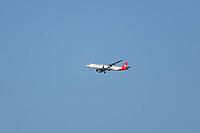 Embraer 195-E2 jet commercial passenger aircraft of Helvetic Airways airline flying in a blue sky on approach to land at London city airport, England, United Kingdom [IBR125423472]