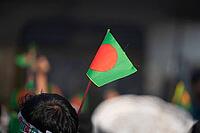 Dhaka, bangladesh- 16 Dec 2025: Bangladesh national flag held during a public celebratory event [IBR125423484]