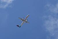 De Havilland Canada DHC-8-400 / Dash 8 Q400 turboprop commercial passenger aircraft of Luxair Luxembourg Airlines flying in a blue sky on approach to land at London city airport, England, United Kingdom [IBR125423496]