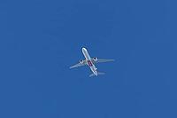 Boeing 777-300ER jet commercial passenger aircraft of Emirates airline flying in a blue sky, England, United Kingdom [IBR125423511]