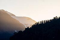 Mountains with forest and glaciated mountain peaks at sunrise, Carretera Austral, near Villa Santa Lucia, Los Lagos, Chile [IBR125423514]