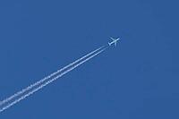Jet commercial passenger aircraft flying in a blue sky with contrails or vapour trails behind in the atmosphere, England, United Kingdom [IBR125423516]