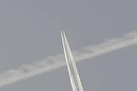 Jet commercial passenger aircraft flying in a blue sky with contrails or vapour trails behind in the atmosphere, England, United Kingdom [IBR125423518]