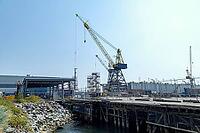 Industrial scene with heavy machinery and structures at a waterfront facility, indicating ongoing development and maritime activity, North Vancouver, BC, Canada [IBR125424514]