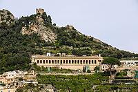 Amalfi town hillside showcasing old ruins, terraced gardens, and traditional architecture under a clear sky [IBR125436233]