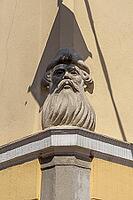 Stone head sculpture of a bearded man with headdress, corner relief, building, Kamnik, Upper Carniola, Slovenia [IBR125436234]