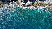 Atlantic Ocean water with underwater rocks washing against the coastline in Tenerife [IBR125436247]