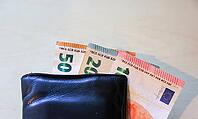Wallet holding diverse Euro banknotes, representing financial transactions and wealth [IBR125436256]