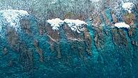 Ocean waves breaking over a beautiful shallow coral reef creating natural patterns in the turquoise water [IBR125436281]