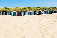 Sandy beach beach with beach huts and blue sky, Wijk aan Zee, North Sea, North Holland, Netherlands [IBR125436292]