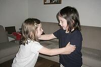 Two young siblings engage in spontaneous physical communication, emotional development and social bonding during indoor playtime in a domestic home, intimate tactile negotiation between toddlers exploring personal space boundaries and mutual affection, ex [IBR125446488]