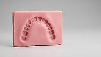 Close-up of a fresh bite indentation pressed into pale pink dental impression wax before casting, pale grey background, forensic odontology procedure photography, AI generated [IBR125446501]