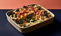 Casserole dish with broccoli and melted cheese. Topped with red sauce and garnished. Served in white ceramic baking dish, AI generated [IBR125448882]