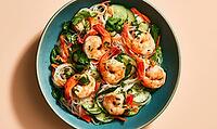 Shrimp and cucumber salad in blue bowl. Fresh herbs, rice noodles, and chili garnish. Vibrant colors, healthy meal concept, AI generated [IBR125448888]