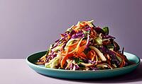 Fresh coleslaw with shredded purple and green cabbage, carrots, and herbs. Served on teal plate against soft purple background. Vibrant, colorful, AI generated [IBR125448896]