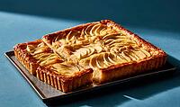Two square apple tarts with sliced apples arranged on top. Golden-brown crust, glossy surface, rustic look, AI generated [IBR125448904]