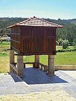Historic espigueiro granary standing in a rural field under a blue sky, demonstrating Portugal's agricultural heritage [IBR125462091]