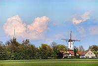 Landscape sight on little village with windmill and churchtower [IBR125462098]