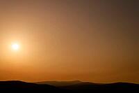 A peaceful sunset over a mountainous landscape with an orange-coloured sky, Maestrazgo (Maestrat, Alto Maestrazgo, l'Alt Maestrat), Spain's Most Beautiful Villages, The Most Beautiful Villages in Spain, the Middle Ages, mountain village, Culla, Costa del  [IBR125462121]