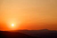 The sun is approaching the horizon and bathing the mountains in orange light, sunset, Maestrazgo (Maestrat, Alto Maestrazgo, l'Alt Maestrat), Spain's Most Beautiful Villages, The Most Beautiful Villages in Spain, the Middle Ages, mountain village, Culla,  [IBR125462134]