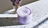 Glass of purple frothy beverage sits on a speckled countertop. Soft light highlights the drink's creamy texture, AI generated [IBR125472264]