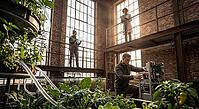 Controlled environment agriculture, automated smart aquaponics research, sustainable food production, circular bioeconomy in repurposed brick architecture, an engineer adjusts sensor units beside nutrient water circulation tanks, researchers analyze biolo [IBR125472308]