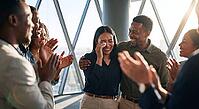 Emotional corporate promotion success, colleagues cheering crying woman in highrise office during recognition announcement, genuine tears of joy, psychological safety and deep empathy in corporate culture, hard earned triumph over systemic hurdles, authen [IBR125472320]