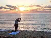 A woman does yoga at sunrise on Tortoli beach, Sardinia, 29.09.2026, Tortoli, Italy [IBR113453106]