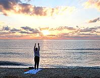 A woman does yoga at sunrise on Tortoli beach, Sardinia, 29.09.2026, Tortoli, Italy [IBR113453109]