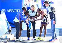 27 September 2026, Athletics: BMW Berlin Marathon 2026, from left: Tigst Assefa (ETH 2:11:04) crosses the finish line, exhausted, and is supported by a team at the 2026 BMW BERLIN MARATHON [IBR113453178]