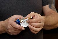 Man holding cigarette box in his hand [IBR125492360]