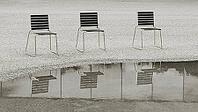 Black and white image of chairs by the water in front of the Bregenz Festival grounds in Bregenz on Lake Constance [IBR125492380]