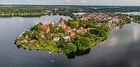 Ratzeburg?s old town island in northern Germany with cathedral, red-roofed houses, the historic town, lake scenery and a sailing boat [IBR125492393]