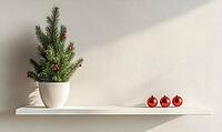 Simple white shelf with a small, green potted fir tree, decorated with a few red ornaments and set against a light gray wall, AI generated [IBR125502160]