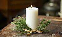 Single white candle with a small brass bell and fir, AI generated [IBR125502180]