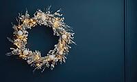 Elegant round holiday wreath with white and gold decorations against a matte dark blue wall, tiny warm lights on the wreath adding a cozy glow, AI generated [IBR125502190]