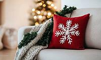 Simple red pillow with white snowflake embroidery on a light gray sofa, AI generated [IBR125502199]