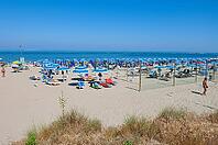 Sandy beach beach with sunbeds and umbrellas on the Adriatic Sea, Punta Marina, Ravenna, Emilia-Romagna, Italy [IBR125521089]