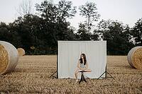 Brown-haired girl, 11, in a cornfield against a beige background [IBR125521125]