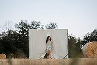 Brown-haired girl, 11, in a cornfield against a beige background [IBR125521135]